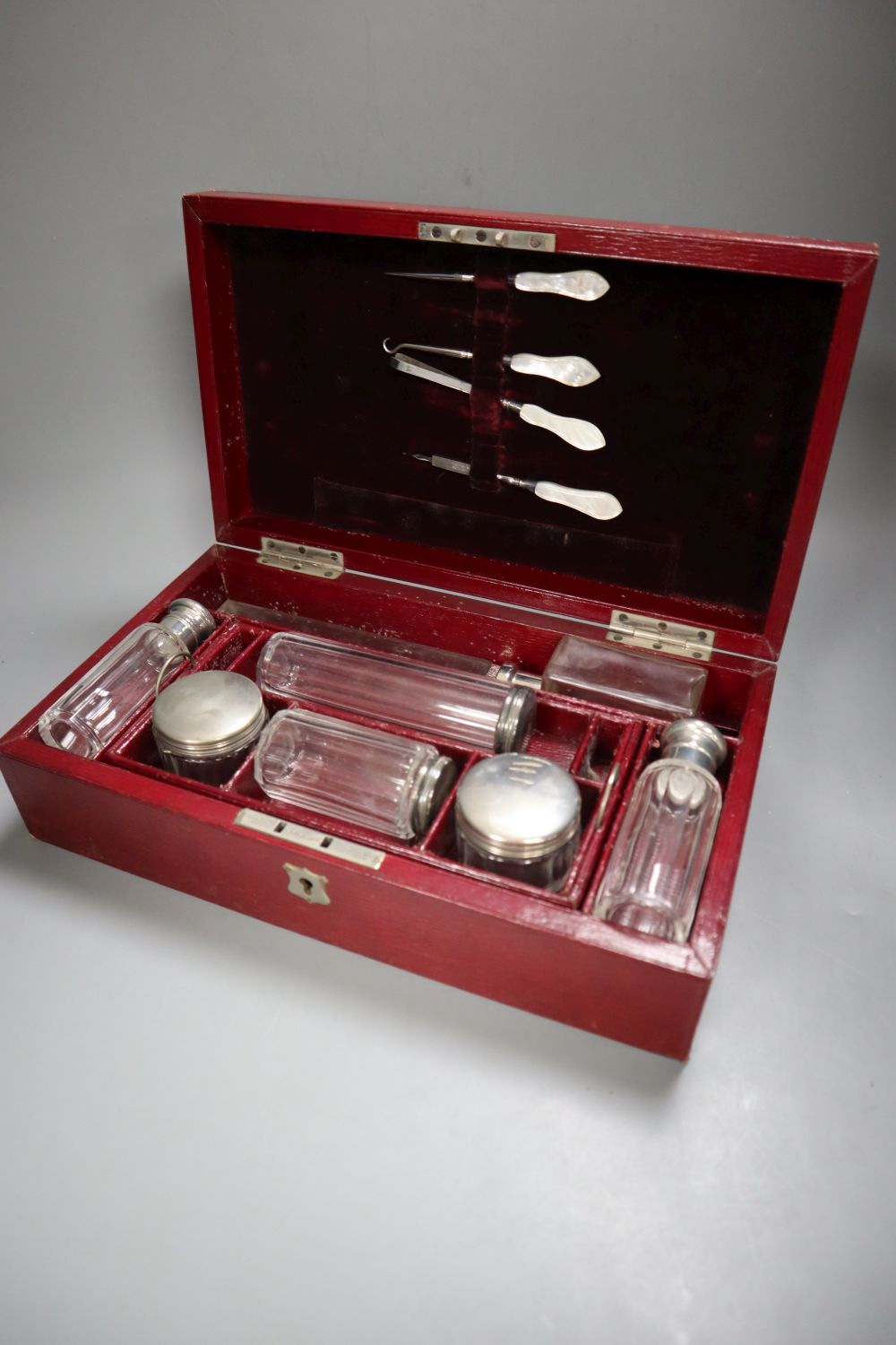 A Victorian ivory inlaid rosewood sewing box, width 30cm depth 22cm height 13cm, and a late Victorian red leather cased travelling toil